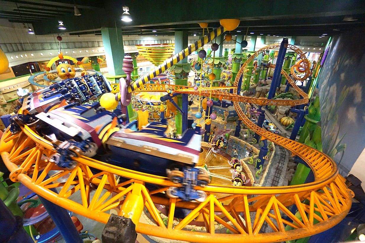 Berjaya Times Square Theme Park Indoor amusement park ride with a colorful rollercoaster track and various whimsical decorations in a vibrant, themed environment.
