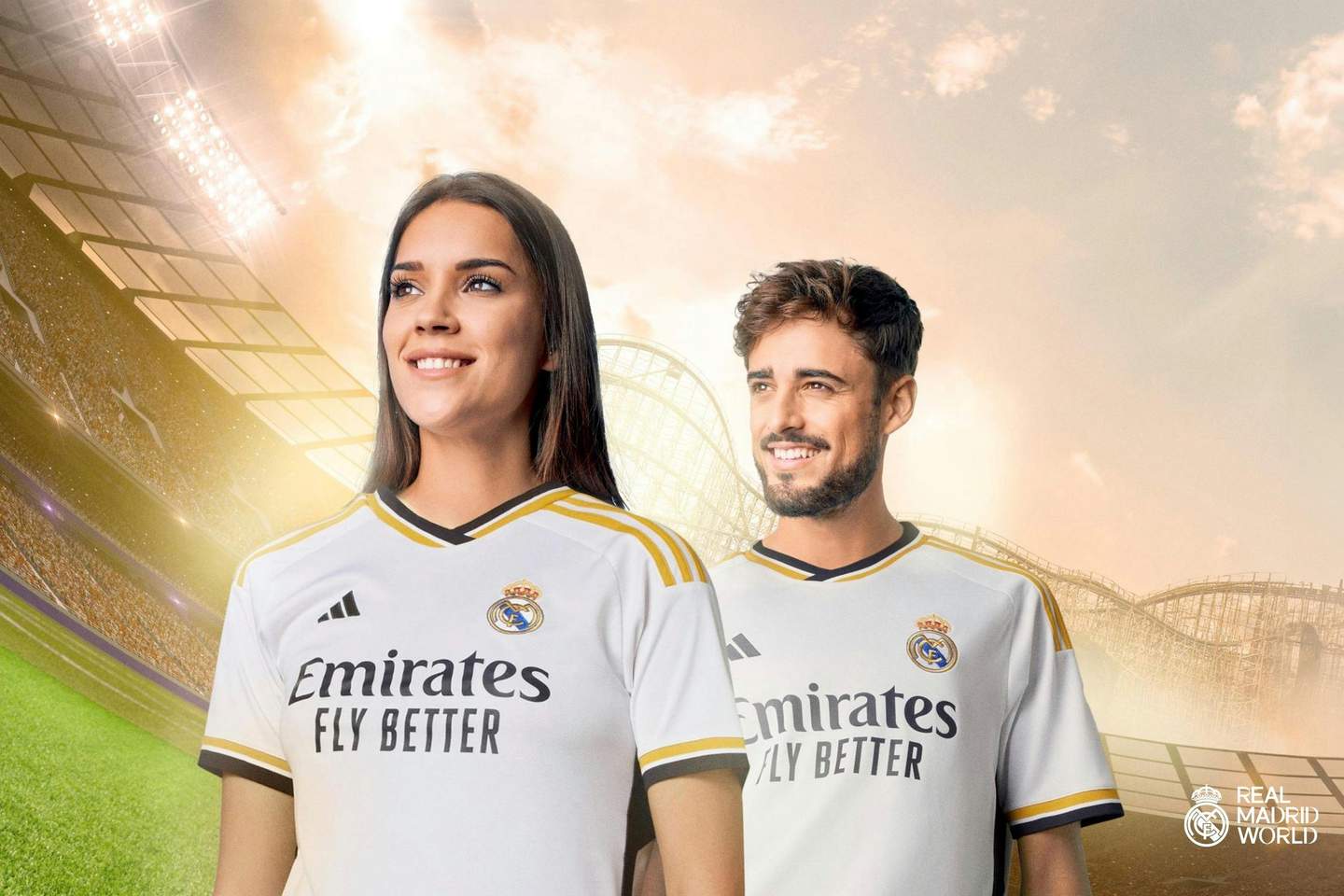 A woman and a man smiling, wearing Real Madrid jerseys, in a brightly lit stadium with a sunset sky. Real Madrid World logo in the corner.