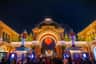 People gather under Tivoli's illuminated archway adorned with festive lights, large nutcracker statues, and a glowing red heart.