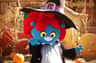A blue cartoon character with red hair and a witch hat poses outdoors near pumpkins and hay bales.