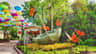 A garden display featuring a large umbrella made of greenery, surrounded by vibrant flowers and oversized monarch butterfly statues.