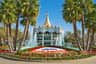 A carousel with ornate decorations surrounded by fountains and flowers, with a sign reading "California's Great America."
